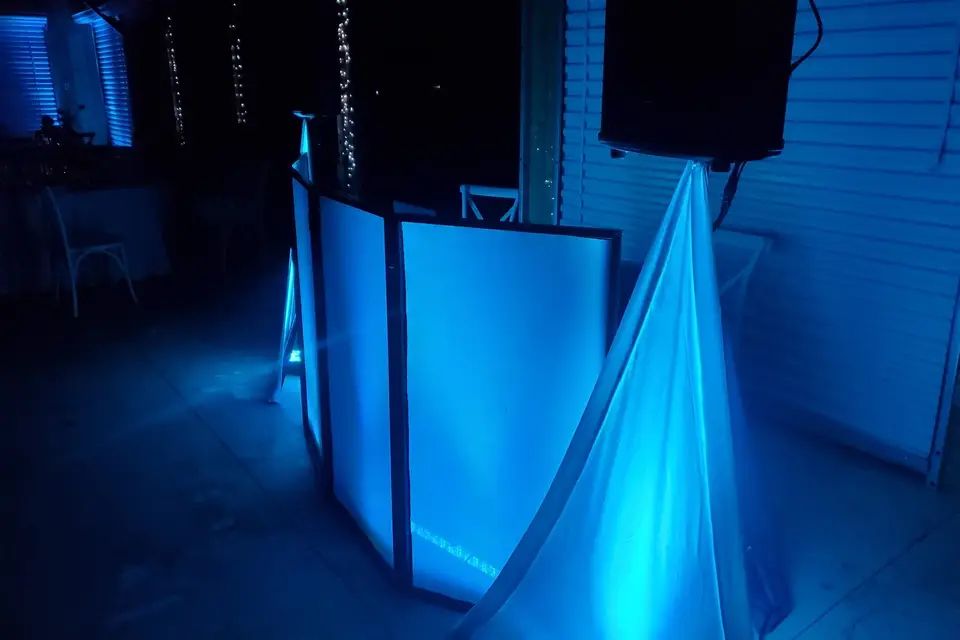 The Hammer DJ Services booth lit blue in a venue before guests arrive
